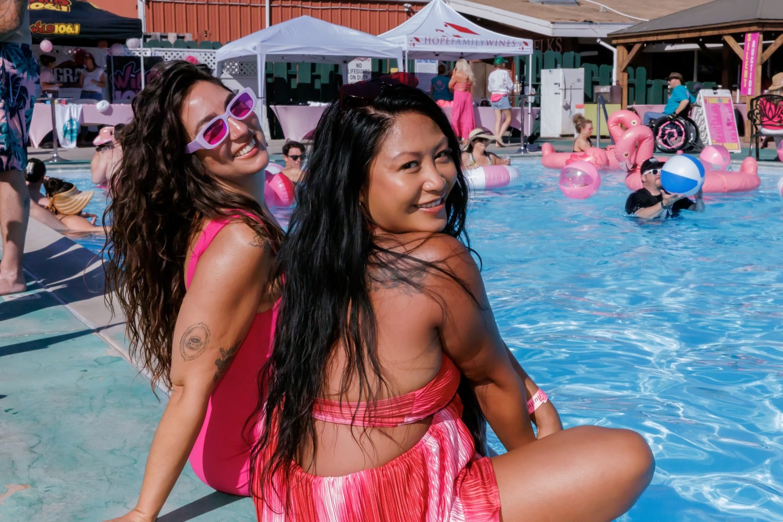 Guests on a flamingo pool float